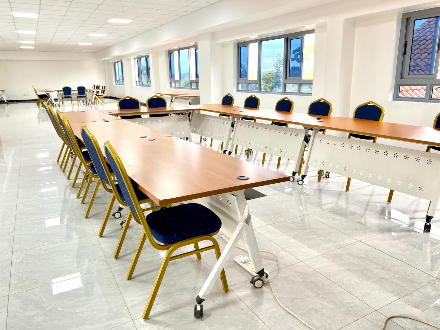 An Enwealth conference room set with long tables and chairs