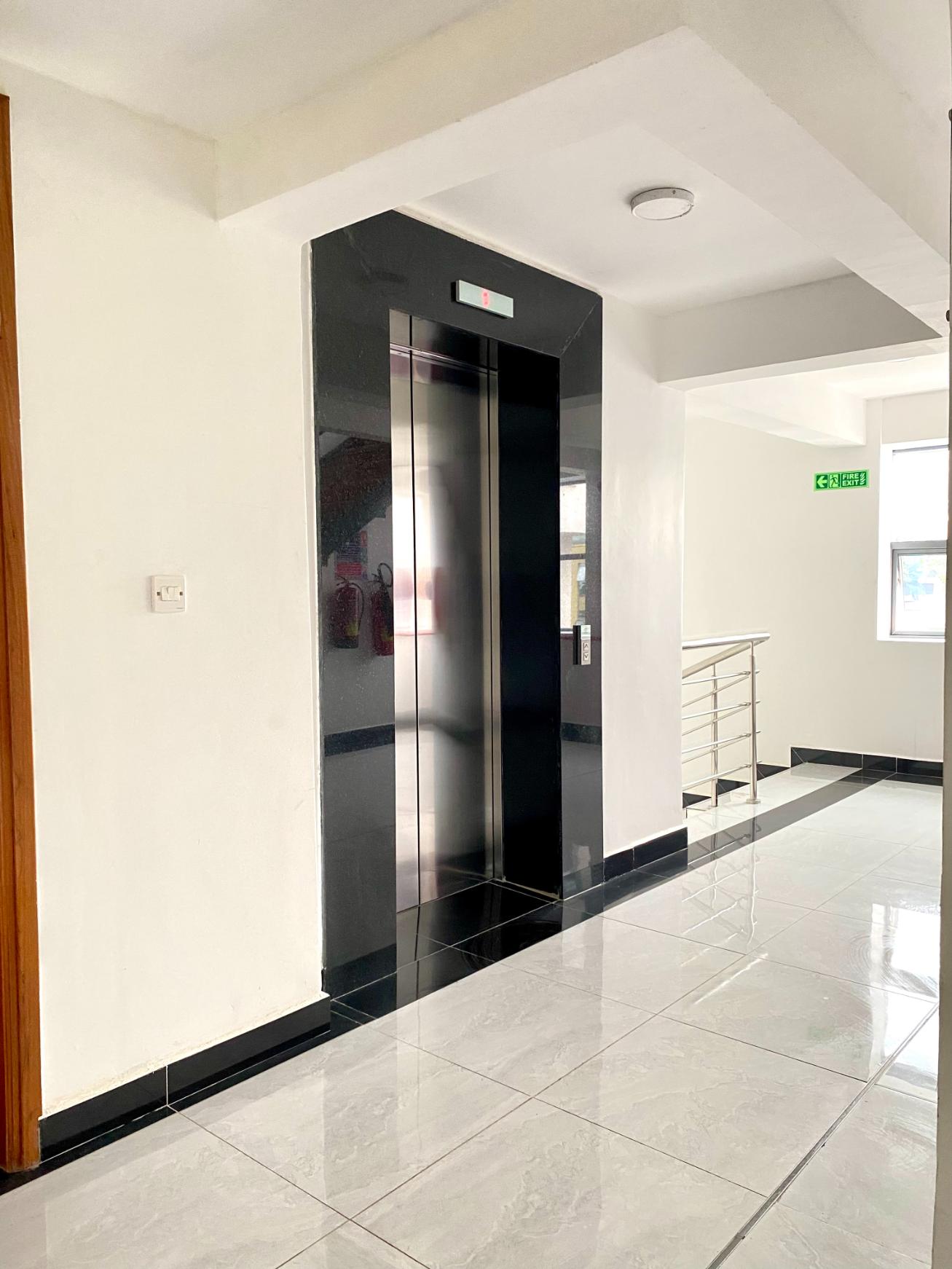 A corridor leading to a lift in Enwealth's building