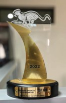A gold 2022 award trophy with a leopard on top