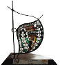 An award trophy with a beaded, African-patterned leaf on a stand