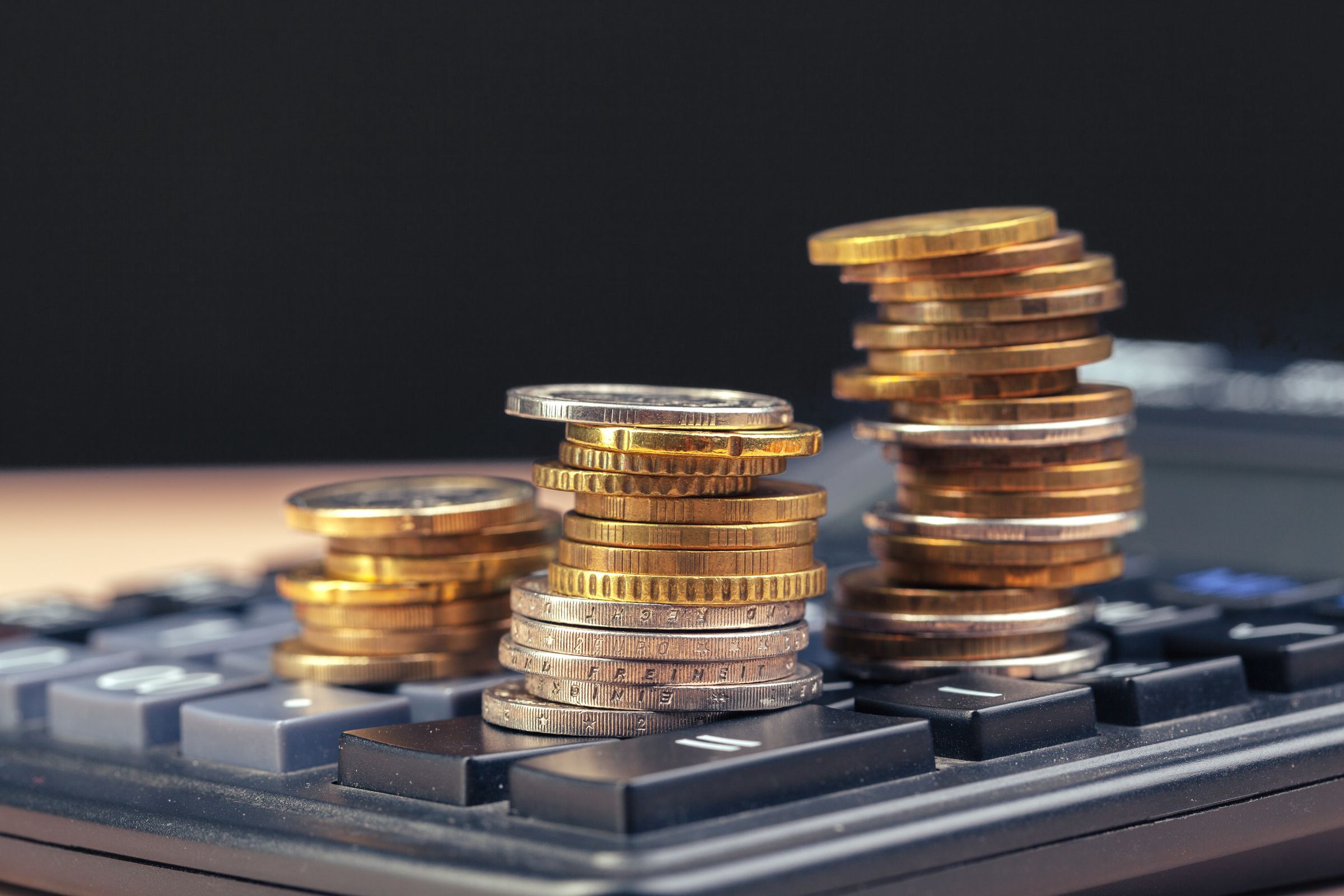 Stacks of coins standing on a calculator keyboard